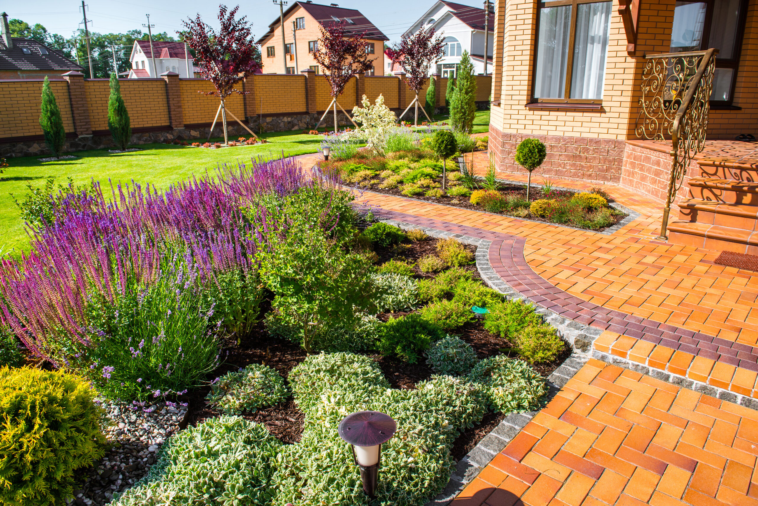 A garden with flowers and bushes in the middle of it.